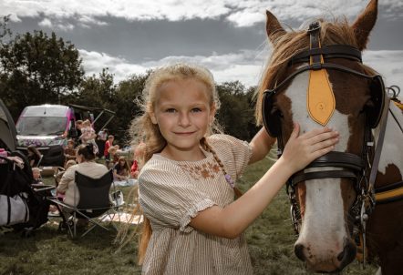 Girl standing next to a horse